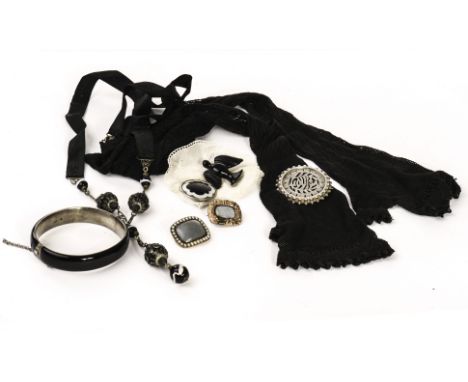 A group of 19th century and later mourning jewels and items, including a gold and pearl mourning brooch, a silver and black e