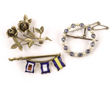 A 9ct gold yachting brooch by Benzie, a 9ct flower brooch, and a 15ct sapphire and seed pearl ring brooch (3)