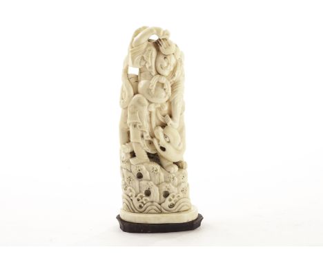 A 19th century Tokyo school carved ivory figural group, the late Meiji period group carved as a warrior fighting a tiger on r