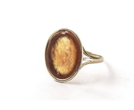 A 19th century unmarked gold intaglio ring, the oval carnelian carved with a Greek profile bust 2cm x 1.7cm