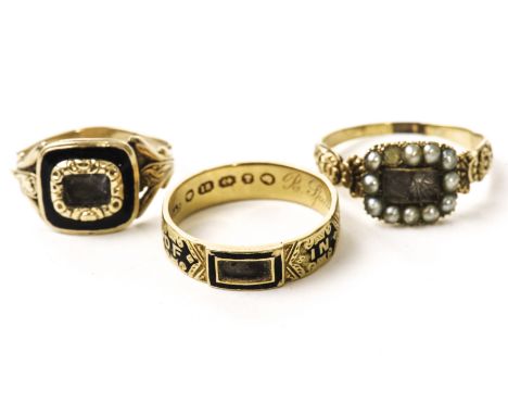 Three Victorian mourning rings, including an 18ct gold example with glazed panel to tablet, one with pearls and glazed panel,