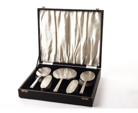 A George VI five piece silver dressing table set from B & Co, presented in a fitted black leatherette case with engine turned