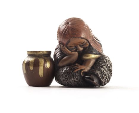A late Meiji period Japanese carved lacquer Shojo netsuke, the intricately carved and well decorated seated figure beside pot