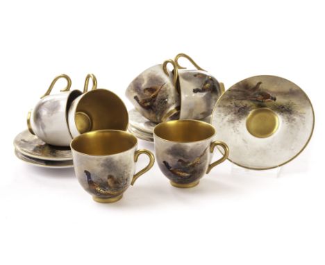 A Royal Worcester six setting coffee set, with pheasant decoration by James Stinton and with gilt interiors. Date marks for 1
