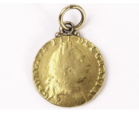 A George III gold spade guinea, dated 1792, with applied pendant bale and ring, worn to (F)