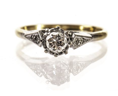 A diamond solitaire engagement ring, the illusion set brilliant cut in white metal having two further stones to the shoulders