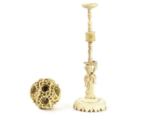 A Chinese 1920s carved ivory puzzle ball, and stand, the outer sphere decorated with dragons in pursuit of the pearl of wisdo