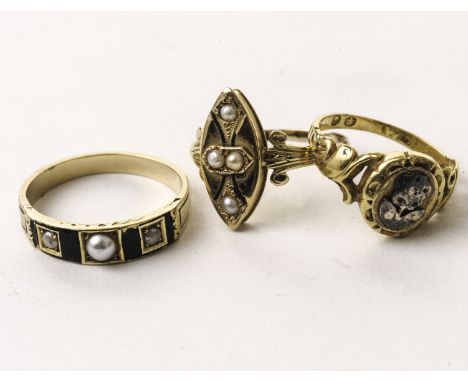 Three Victorian mourning rings, including one with three pearls and black enamel, one with navette shaped tablet and one with