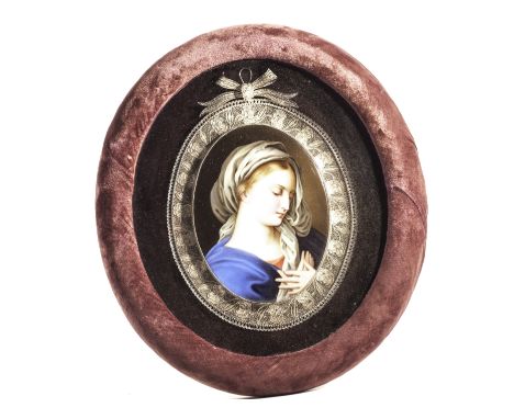 A 19th century German porcelain plaque, possibly Berlin, the oval portrait of a renaissance Madonna presented in a filigree w