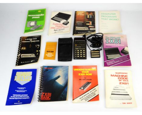 A Hewlett Packard HP-80 calculator and an assortment of vintage computing instruction manuals Condition Report:  Items are in