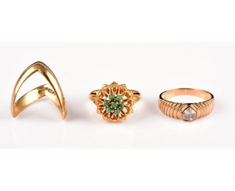 Three gold rings, including a cz heart ring in 9 ct, size M a green paste ring in 18 ct, size K, and a wishbone ring in 9 ct,