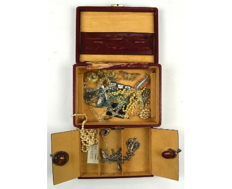 A red leather jewellery box containing costume jewellery, including two silver amber pendants, nouveau style silver pendant a