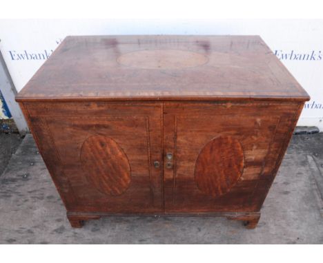 A George III mahogany cupboard, alterations, inlaid with ovals and chequer banding, interior with pine shelves, on bracket fe