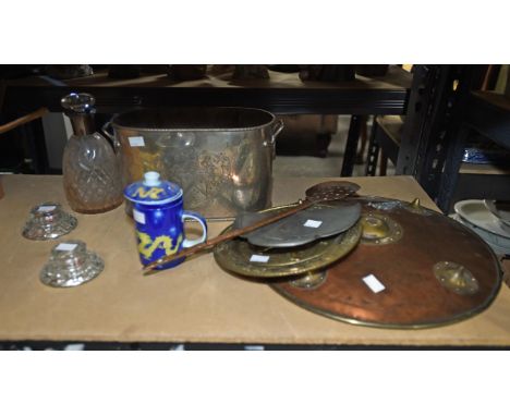 A circular copper and brass shield, 1900s, together with a cast copper skimmer, a brass embossed plate, an Art Nouveau pewter