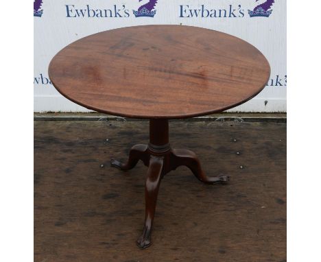 A George II mahogany tripod table, the two piece tilt-top on a gun barrel column with cabriole legs ending in trefoil feet, H