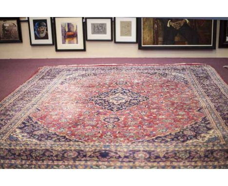 KASHAN BORDERED CARPET
decorate with a large central medallion on a floral filled field, on a blue ground, 383cm long, 295cm 