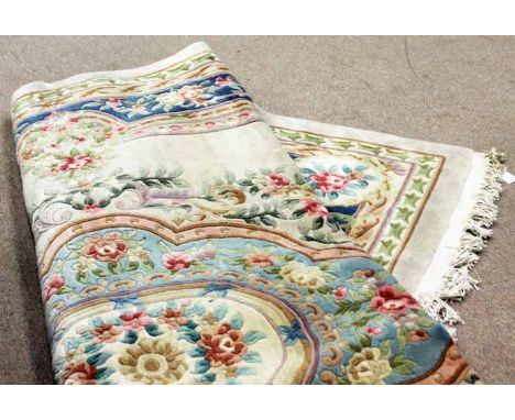 CHINESE BORDERED CARPET 
decorated with a large central floral medallion on a cream natural fround, 270cm x 360cm 
