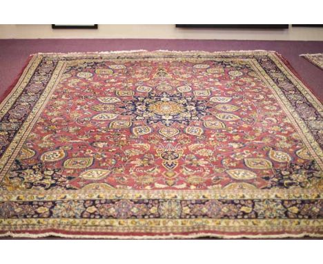 SABZWAR BORDERED CARPET
decorated with a large central floral medallion, on a crimson ground, 403cm long, 295cm wide