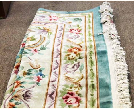 CHINESE BORDERED CARPET
decorated with a large central floral medallion, on a green ground, 280cm x 350cm  
