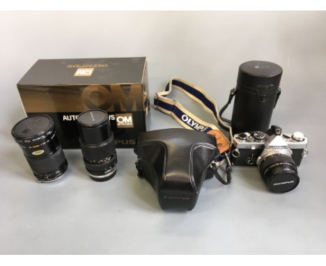 An Olympus OM10 cased camera, OM-2, OM 200mm F4 lens in case, OM auto bellows in box, OM 150mm lens and Kiron HDYA 67mm Skyli