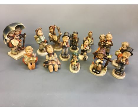 Fourteen Goebel figurines including school boy, boy with bird, children under umbrella, girl singing with bird, girl in tree,