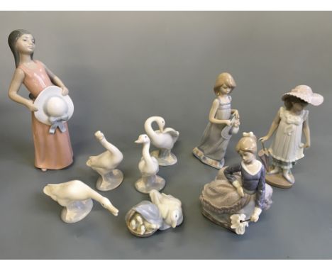 Eight Lladro figurines, five ducks and three females, with one Nao female with umbrella,