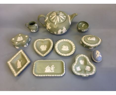 Eleven Wedgwood green and blue jasperware items including teapot, jug, lidded pots, small trays, etc.