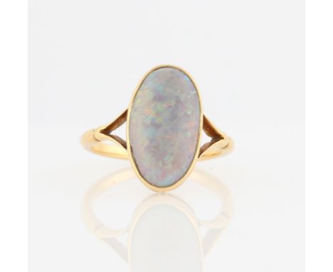 A yellow gold opal ring, set with an oval opal cabochon, measuring approx. 17x11mm, stamped 18ct, ring size O.