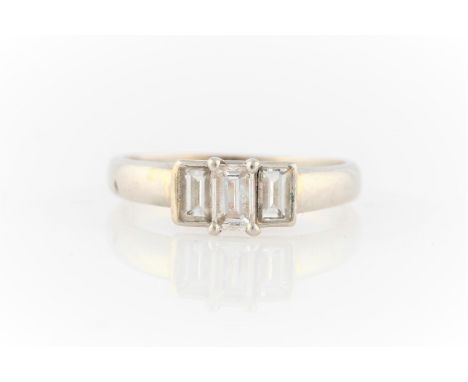 A hallmarked platinum three stone diamond ring, set with rectangular cut diamonds, total diamond weight approx. 0.55ct, ring 