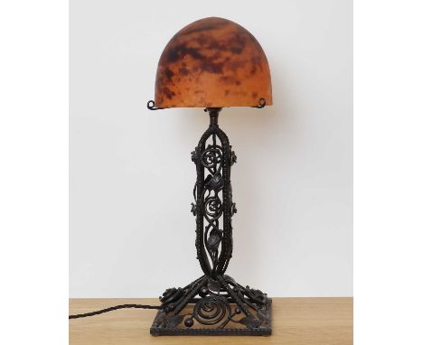 A Daum glass and wrought iron table lamp,early 20th century, with a domed and mottled glass shade, with engraved 'Daum Nancy'