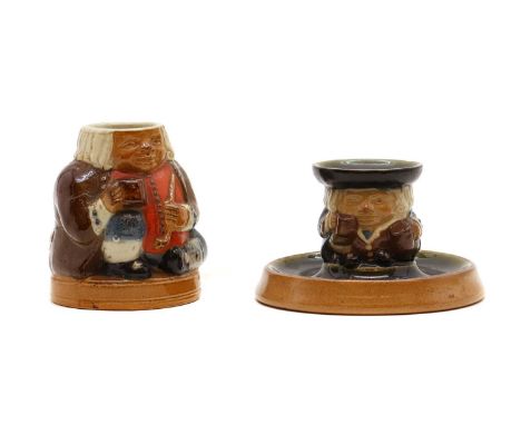 A Doulton Lambeth stoneware candlestick,modelled as a toby jug style figure, impressed marks, no. 8594, 11.5cm diameter7.5cm 