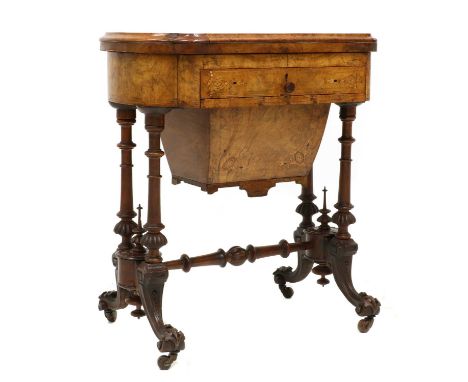 A Victorian walnut combination games and work table,the fold over top with a cribbage and backgammon board with a chessboard 