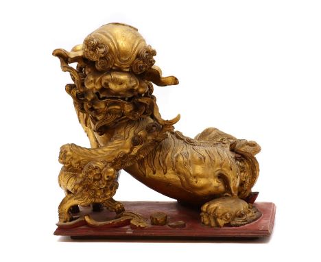 A Chinese gilt wood carving,c.1900, of a Buddhist lion playing with a pup,28.5cm longCondition ReportCracks, chips, losses an
