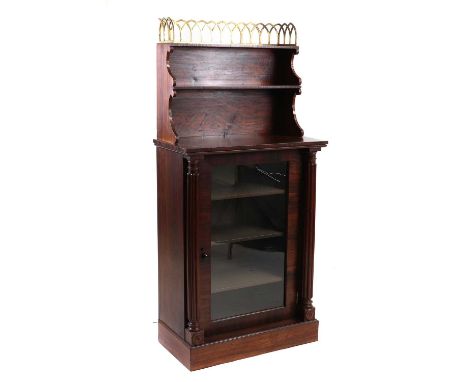 A Regency rosewood cabinet, in the gothic style, with gilt brass gallery and open shelves above a glazed door flanked by gadr