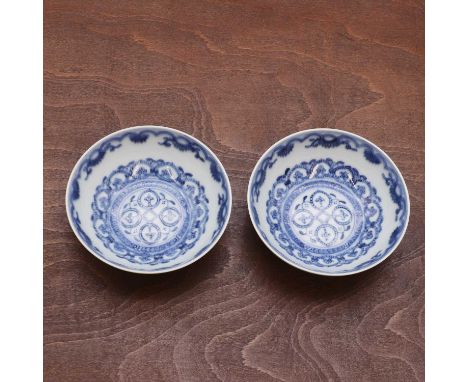 A pair of Chinese blue and white saucers,20th century, the interior painted with diagonal decoration, the underside with prun