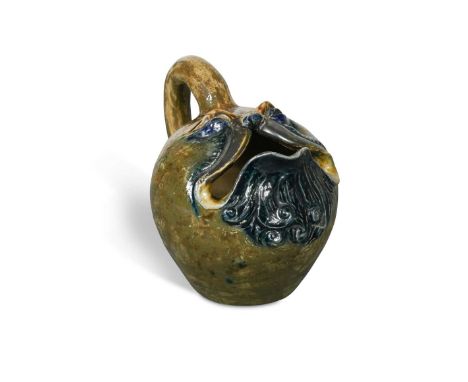 Robert Wallace Martin for the Martin Brothers, a stoneware spoon warmer, glazed in shades of green, blue and ochre, the ovoid