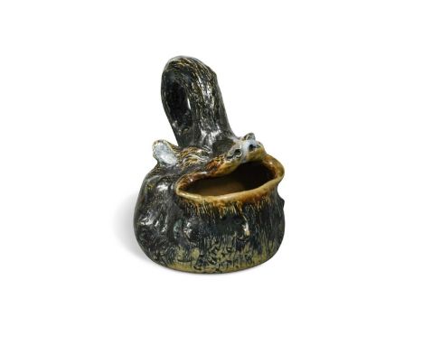 Robert Wallace Martin for the Martin Brothers, a stoneware spoon warmer, 1881, glazed in shades of brown and green, modelled 