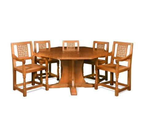 Robert 'Mouseman' Thompson, an oak dining table and eight chairs, the table with adzed octagonal top to a central cruciform s