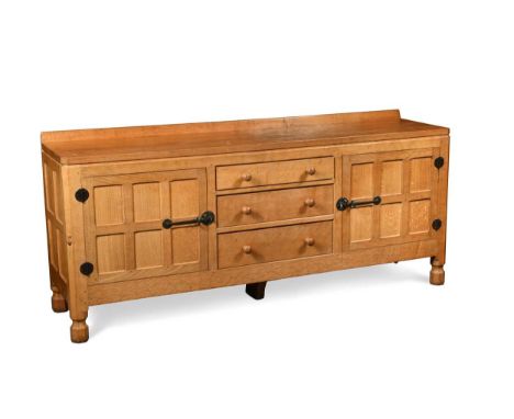 Robert 'Mouseman' Thompson, an oak sideboard, the adzed top three central drawers flanked by panelled cupboard doors to eithe