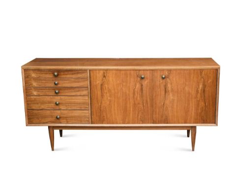 A mid-century teak and rosewood sideboard, with five graduated drawers and a pair of cupboard doors raised on tapering legs78