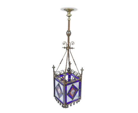 An Arts &amp; Crafts stained glass hall lantern, the wrought iron frame with leaded stained glass panels117cm highCondition r