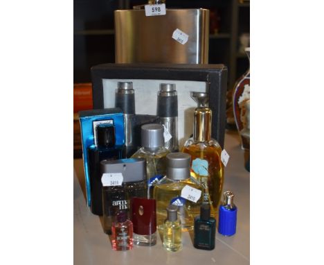 A large novelty hip flask, Binoculars, and a collection of gents fragrances.