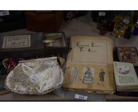 A late 1940s school scrap book on fashion through the ages,evening bags, a vintage pack of cup reading fortune cards and more