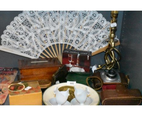 A selection of curios and decorations including brass twist stem lamp base Ilford camera and trinket cases