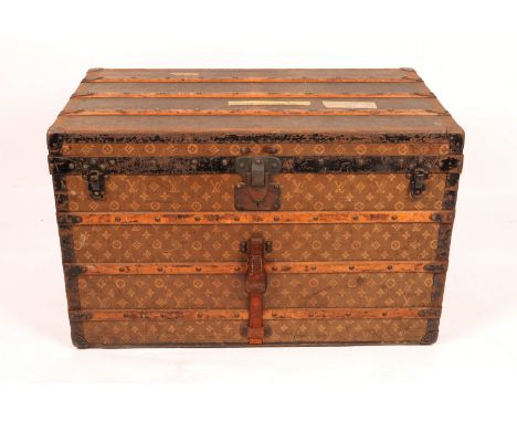A LOUIS VUITTON CABIN TRUNK with monogram decoration, the lined interior with two trays, labelled Louis Vuitton, 1 Rue Scribe