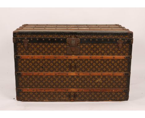 A LOUIS VUITTON RECTANGULAR CABIN TRUNK with stylistic monogram decoration, metal and wooden bound with two interior trays, l