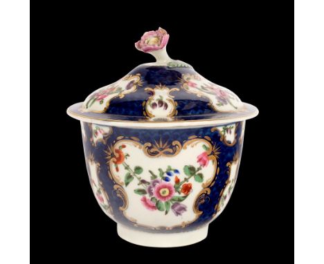 A Worcester blue scale ground sugar bowl and cover, circa 1770, painted flowers in gilt frame cartouches, 13cm high/Provenanc