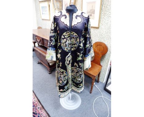 A Chinese mandarin robe, circa 1870, dark blue with roundels of ladies at leisure in gardens, relined/see illustration CONDIT