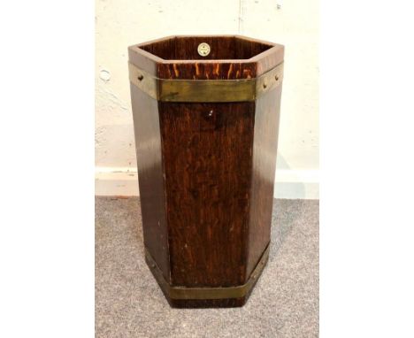 A hexagonal oak stick stand, brass bound, bearing a label for R A Lister and Co Ltd Dursley 51cm high, 27cm wide CONDITION RE