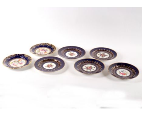 A set of three Chamberlains Worcester blue ground dessert plates, circa 1810, painted central flowers with gilt scroll border